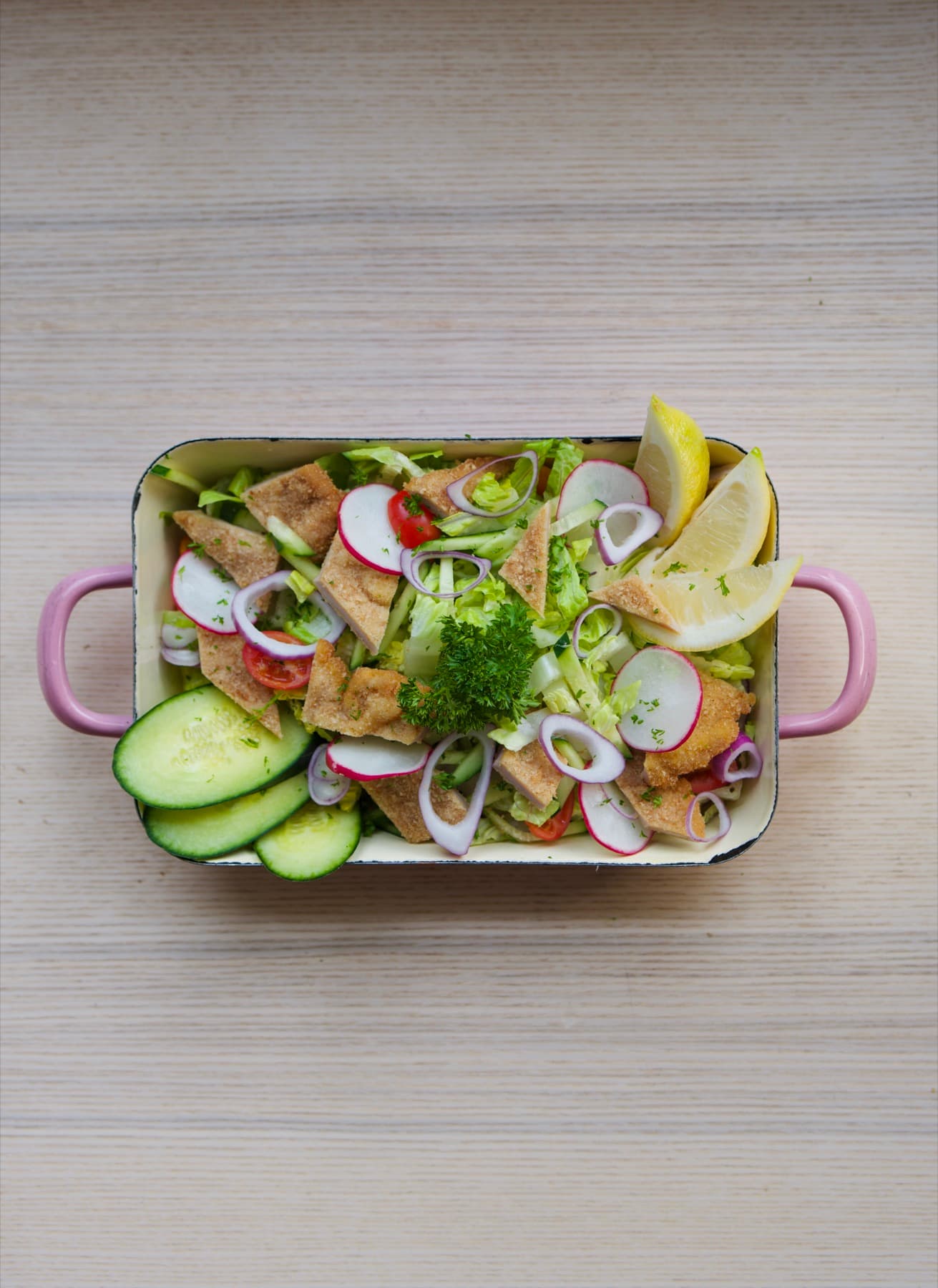 Schnitzel salad tray with radish, cucumber and lemon