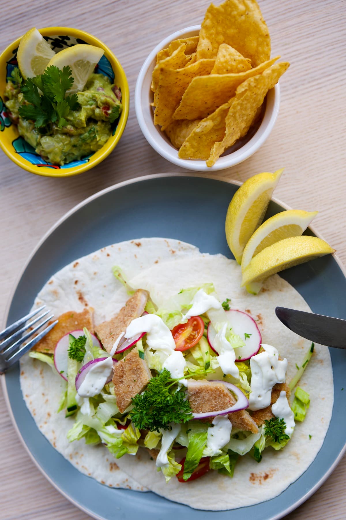 Street-style schnitzel taco with crema, radish and tomato